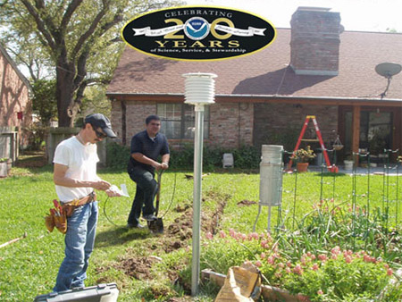 National Weather Service employees from the Weather Forecast Office in Corpus Christi, Texas, install 
							a temperature sensor and a rain gauge