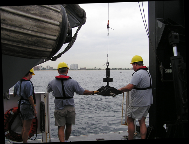 Scientists deploying a Shipek Sediment Sampler
