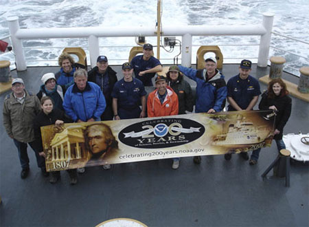 Several NOAA representatives and guests participate in a NOAA-funded marine debris removal project