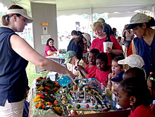 At the Smithsonian Folklife Festival, NOAA staff teach children how chemicals and pollutants can enter into drainage paths that flow into the Chesapeake Bay