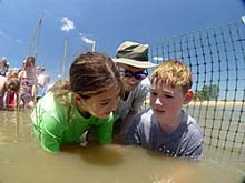 Children learn how to plant wetlands grasses at NOAA Restoration Day