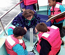 Students study a water sample taken form the Monterey Bay National Marine Sanctuary. 