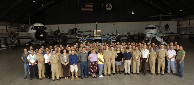 AOC civilians and NOAA Corps officers gather in the NOAA hangar for a group picture