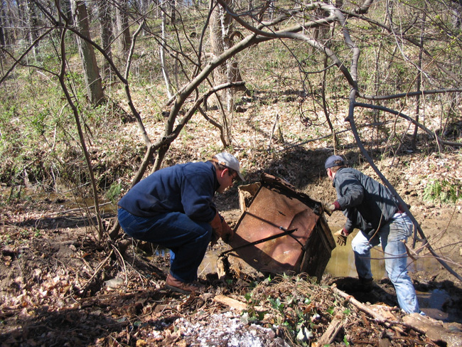 NOAA National Ocean Service Assistant Administrator, Jack Dunnigan, helps Jim Connelly, Anacostia Watershed Society Executive Director, remove a refrigerator from the Watts Brach tributary, February 2006.