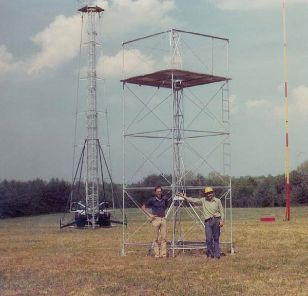 A Peck Tower in the foreground with the designer R. Peckenpaugh on the right. In the background are a Truck Mounted Observing Tower at the left and a Swedish Pole