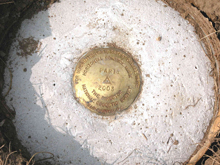 A National Geodetic Survey brass disk set in concrete.