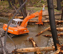 woody debris is placed in a stream to create habitat suitable for spawning salmon