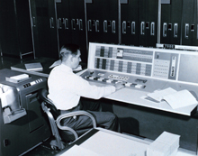 A meteorologist at the console of the IBM 7090 electronic computer in the Joint Numerical Weather Prediction Unit. 