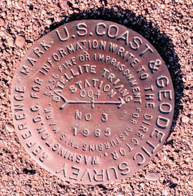 Brass monuments permanently affixed in concrete or surrounding bedrock indicate accurate geodetic reference positions within the National Geodetic Survey's horizontal and/or vertical datums.